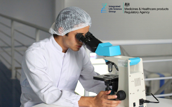 Header image showing a pharmacy lab worker looking through a microscope (Life Science Consulting, pharma consulting)